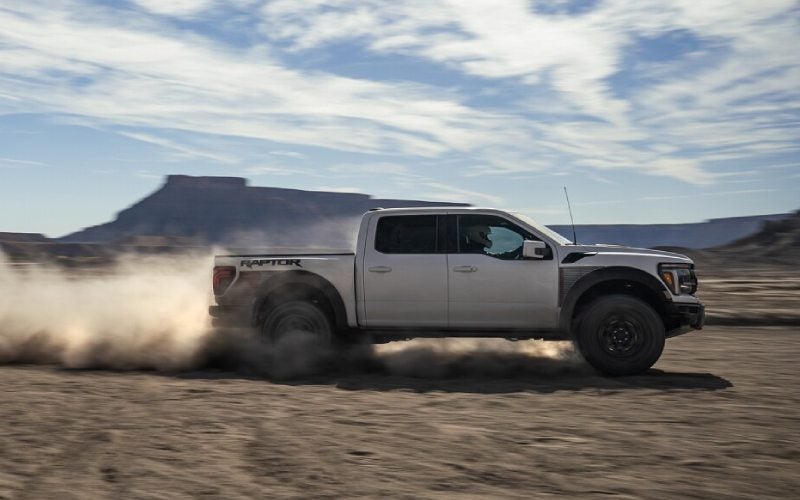 Ford F-150 pickup driving on a dirt road