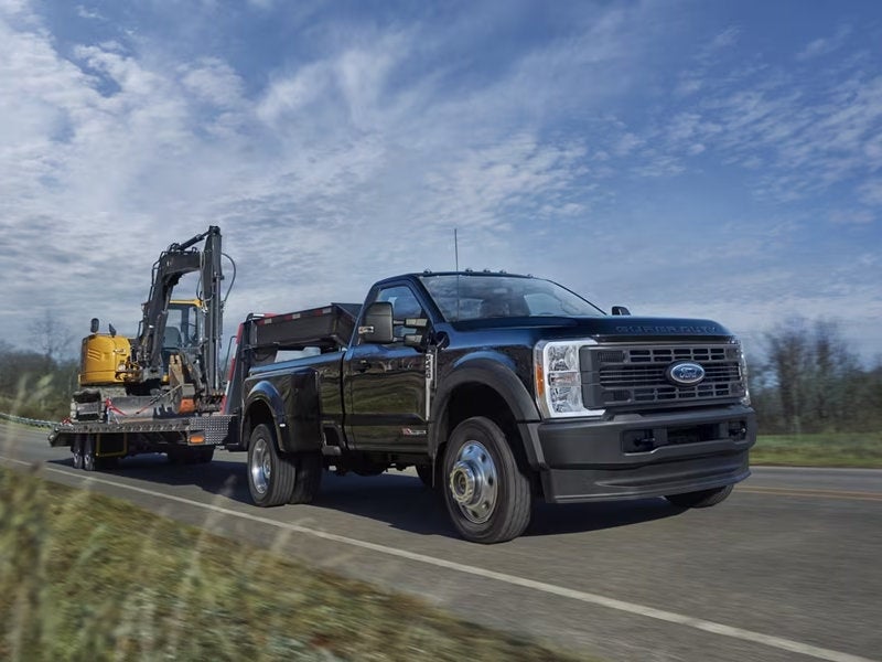 Ford Super Duty towing an excavator on a trailer